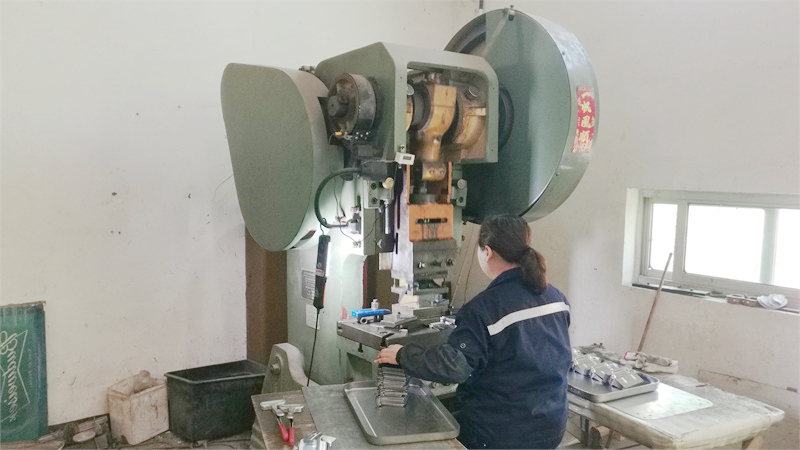 Manufacturing partner operating a stamping press to form metal cooler components